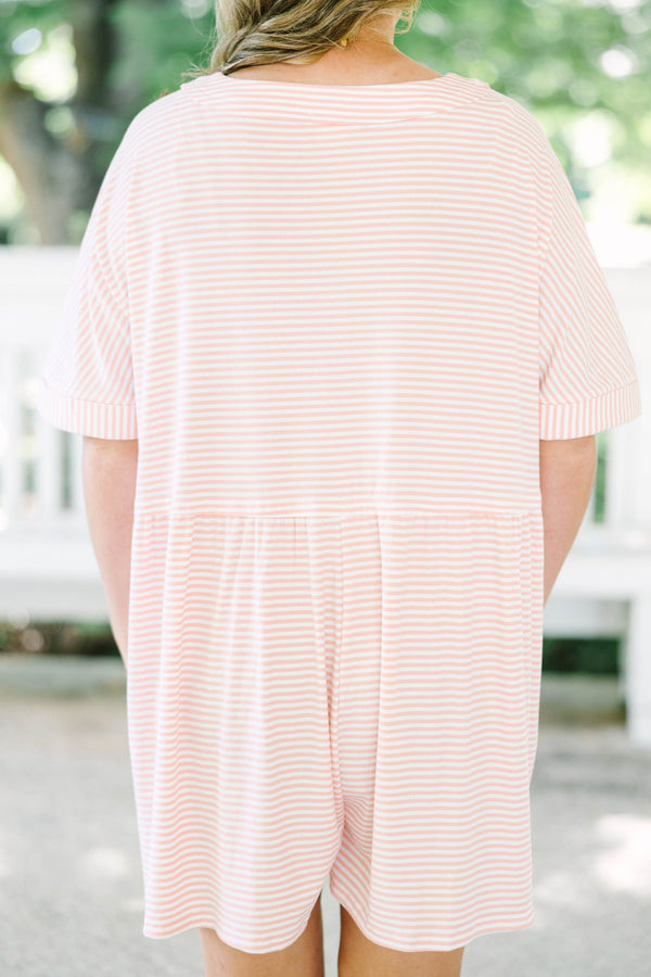 Plus size pink and white striped romper with a flowy fit, V-neck, and functional front buttons.