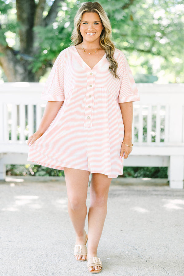 Plus size pink and white striped romper with a flowy fit, V-neck, and functional front buttons.