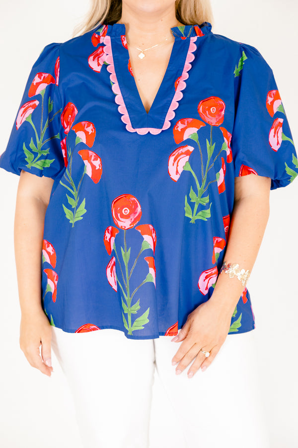 Chic Soul plus size clothing, blue top with short bubble sleeves a floral block pattern throughout and pink scalloped detailing outlining the v-neckline