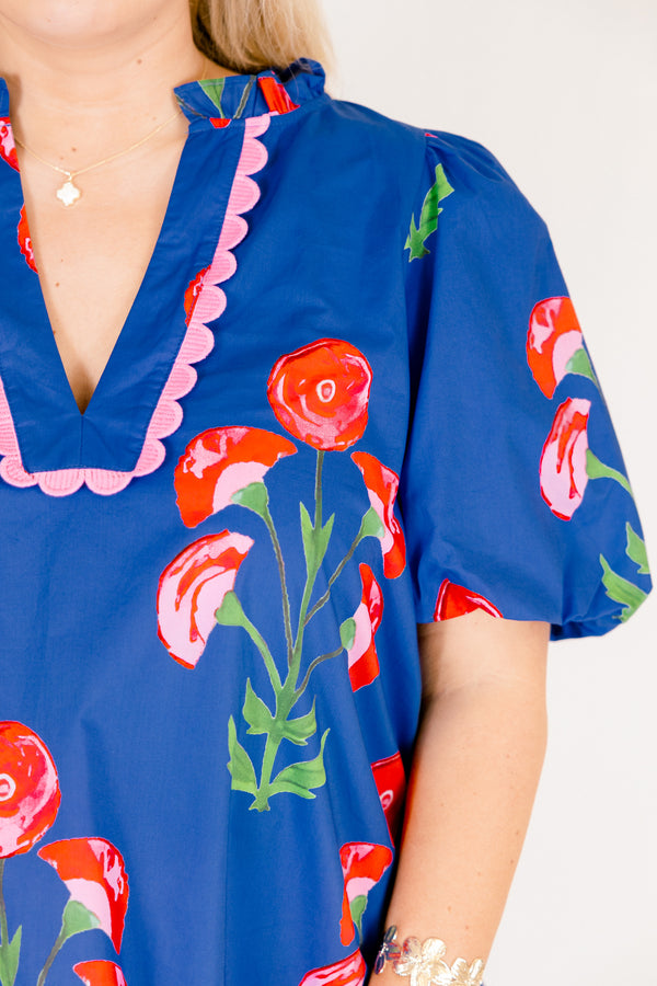 Chic Soul plus size clothing, blue top with short bubble sleeves a floral block pattern throughout and pink scalloped detailing outlining the v-neckline