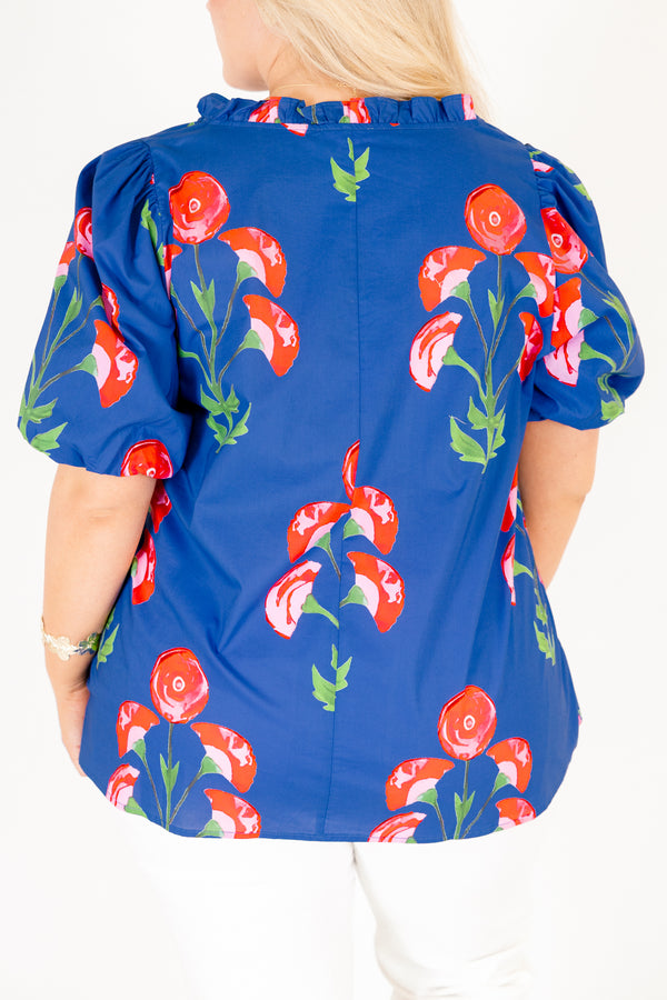 Chic Soul plus size clothing, blue top with short bubble sleeves a floral block pattern throughout and pink scalloped detailing outlining the v-neckline