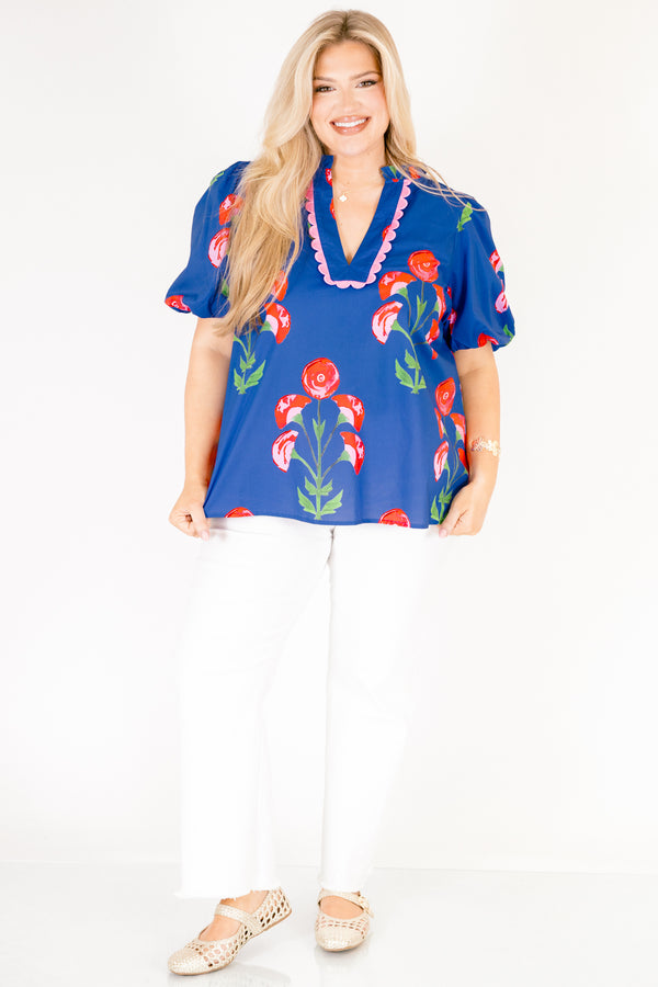 Chic Soul plus size clothing, blue top with short bubble sleeves a floral block pattern throughout and pink scalloped detailing outlining the v-neckline