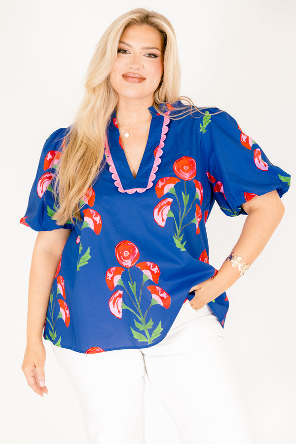 Chic Soul plus size clothing, blue top with short bubble sleeves a floral block pattern throughout and pink scalloped detailing outlining the v-neckline