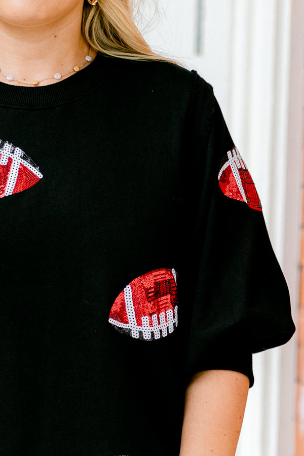 Chic Soul plus size clothing, black top with bubble sleeves that has red sparkly football patches throughout the shirt 