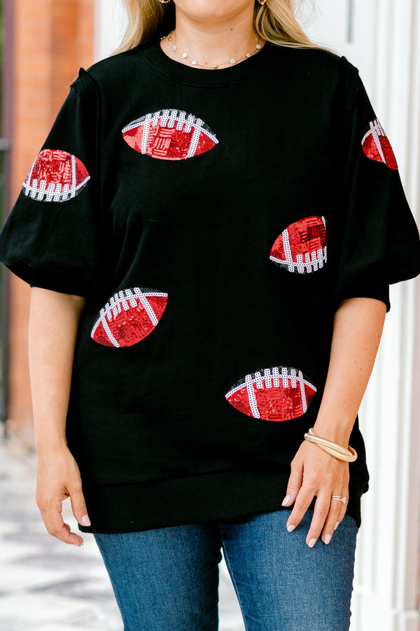 Chic Soul plus size clothing, black top with bubble sleeves that has red sparkly football patches throughout the shirt 