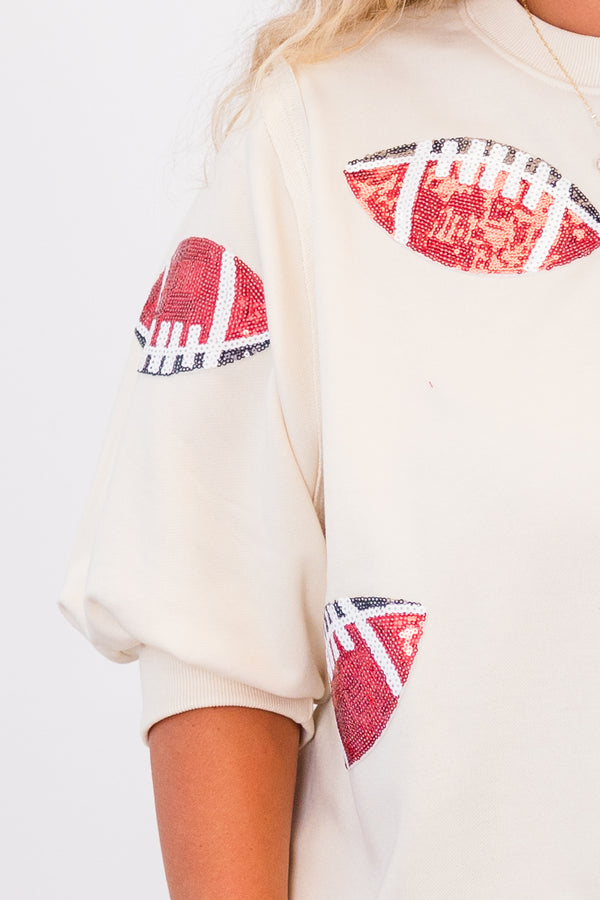 Chic Soul plus size clothing, short-sleeve ivory high-scoop-neckline top with puffed sleeves and sequined red and black footballs scattered across top