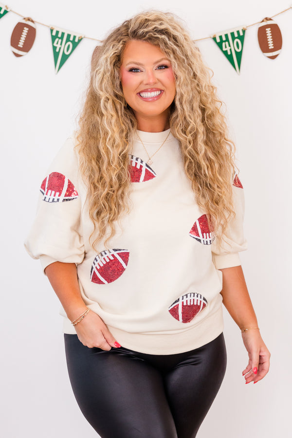 Chic Soul plus size clothing, short-sleeve ivory high-scoop-neckline top with puffed sleeves and sequined red and black footballs scattered across top