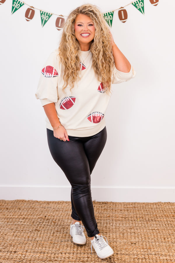Chic Soul plus size clothing, short-sleeve ivory high-scoop-neckline top with puffed sleeves and sequined red and black footballs scattered across top