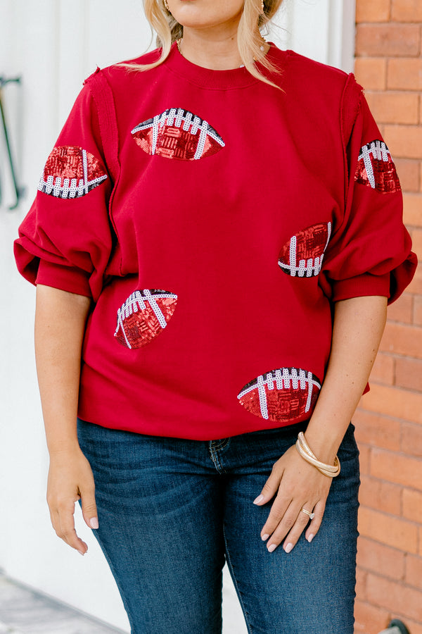 Chic Soul plus size clothing, red top with bubble sleeves that has red sparkly football patches throughout the shirt 