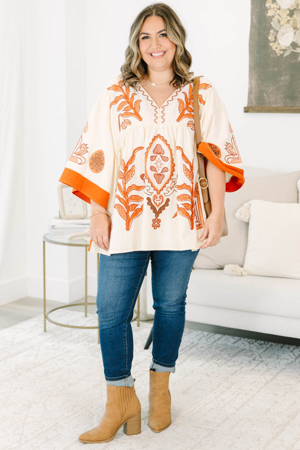 Plus size clothing, cream colored tunic top with orange embroidery
