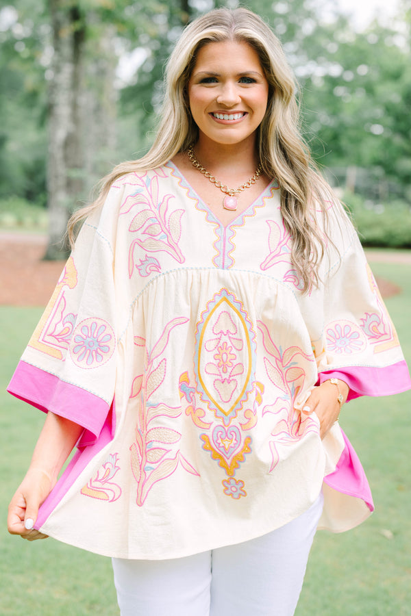 Plus Size cream tunic top with pink and yellow embroidery, V-neckline, and wide bell sleeves.