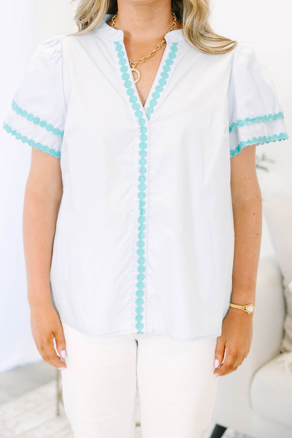 Plus size blue cotton top with split v-neck, flutter sleeves, and teal polka dot trim detailing.