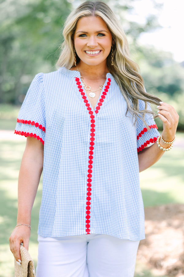Plus size blue gingham top with red dot trim and a flowy, relaxed fit.