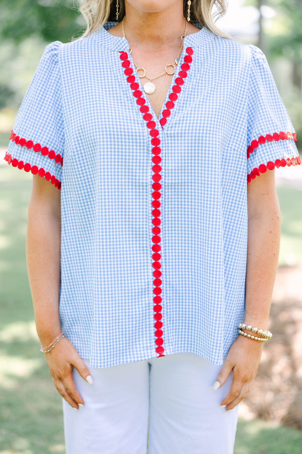 Plus size blue gingham top with red dot trim and a flowy, relaxed fit.