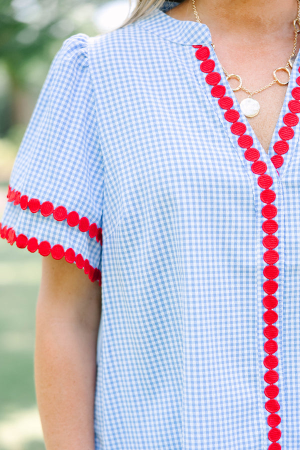 Plus size blue gingham top with red dot trim and a flowy, relaxed fit.