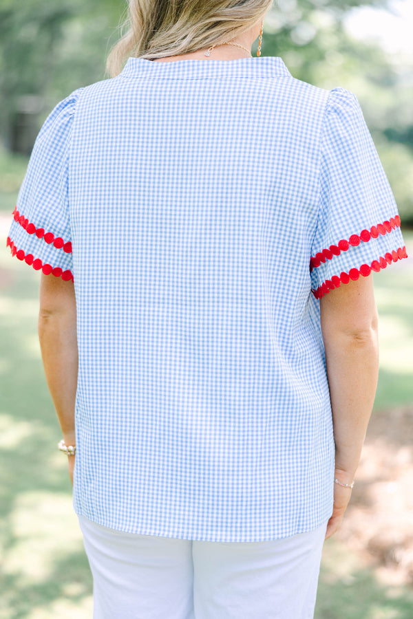 Plus size blue gingham top with red dot trim and a flowy, relaxed fit.