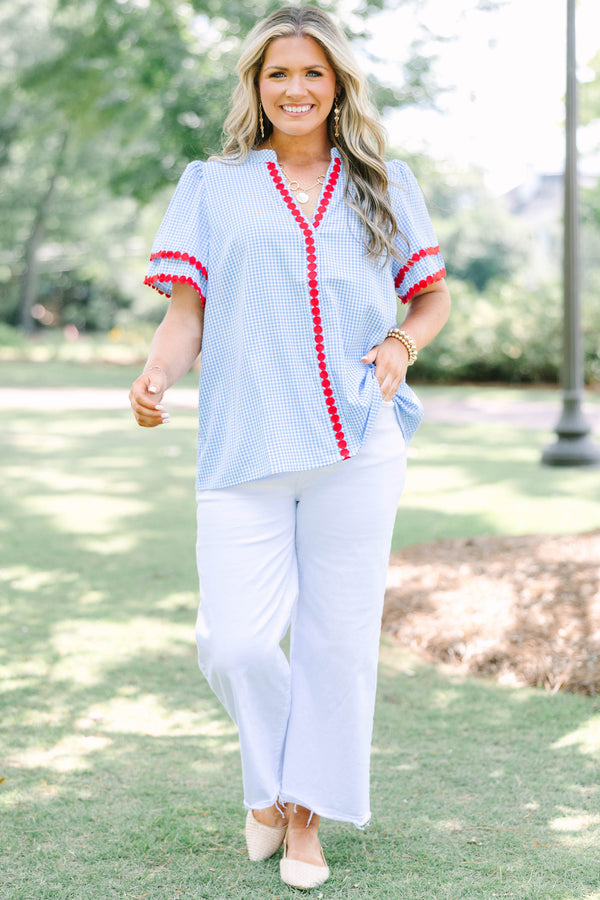 Plus size blue gingham top with red dot trim and a flowy, relaxed fit.