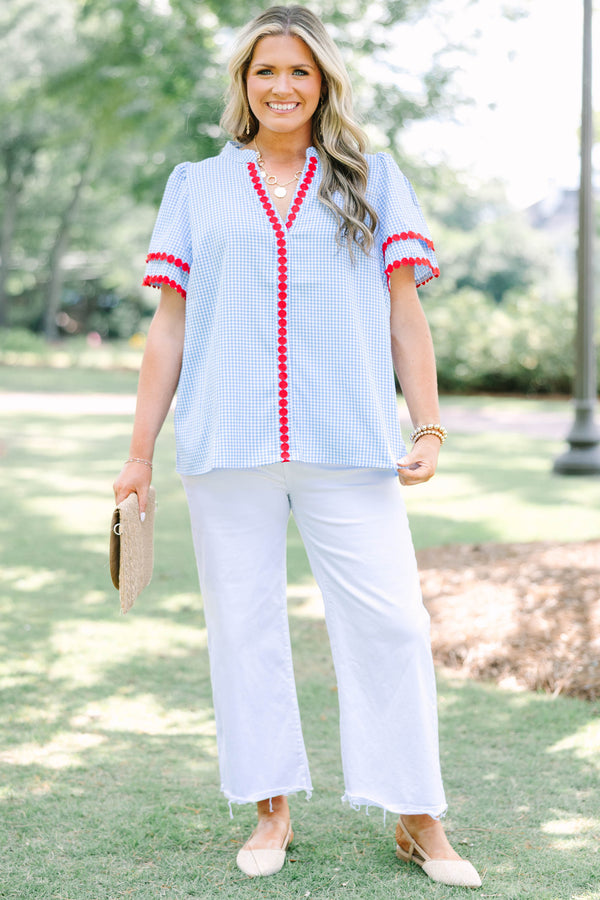 Plus size blue gingham top with red dot trim and a flowy, relaxed fit.