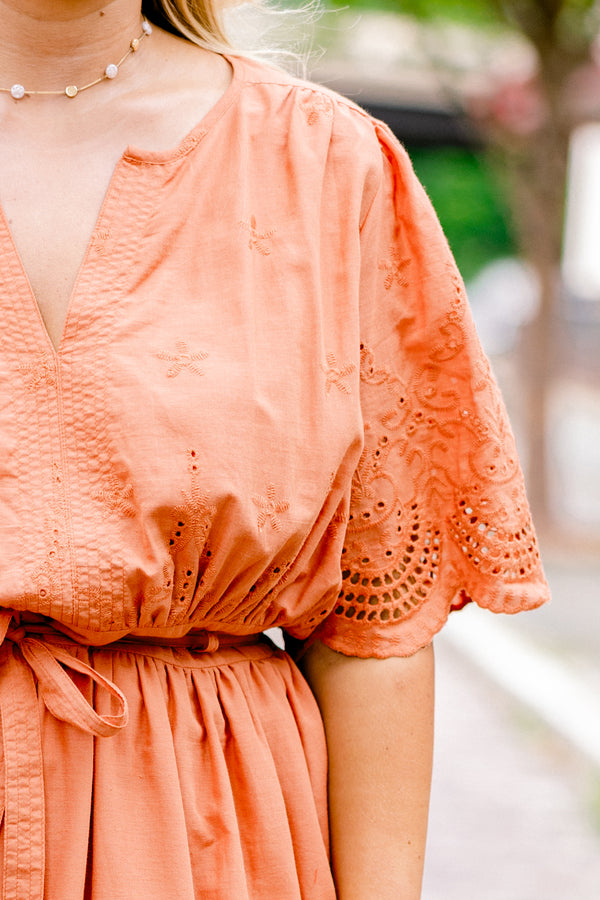 Chic Soul plus size clothing, orange short sleeve midi dress with v-neck and tie belt at the waist and embroidered detailing on the sleeves, top, and hem of the dress