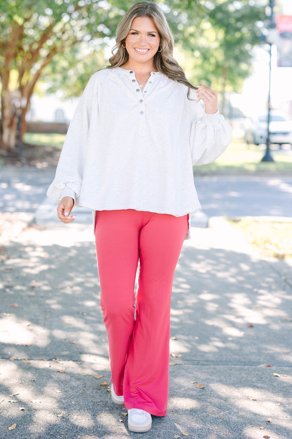 Plus Size high-rise flare leggings in coral with a wide waistband and smooth, stretchy fabric.
