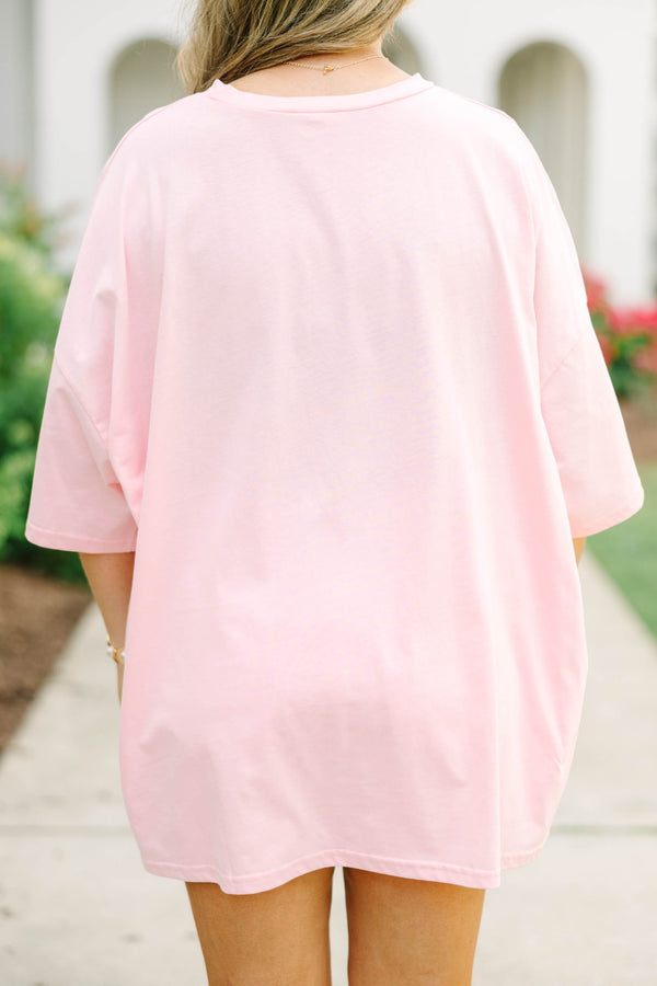 Plus Size dusty pink oversized boyfriend tee with a palm tree graphic and white denim shorts.