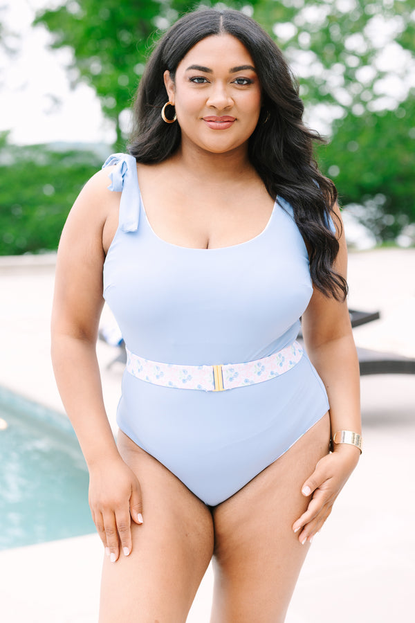 Chic Soul Plus Size Clothing, a blue one-piece swimsuit with bows at the top of the tank style sleeves and a contrast blue floral print belt with a golden clasp
