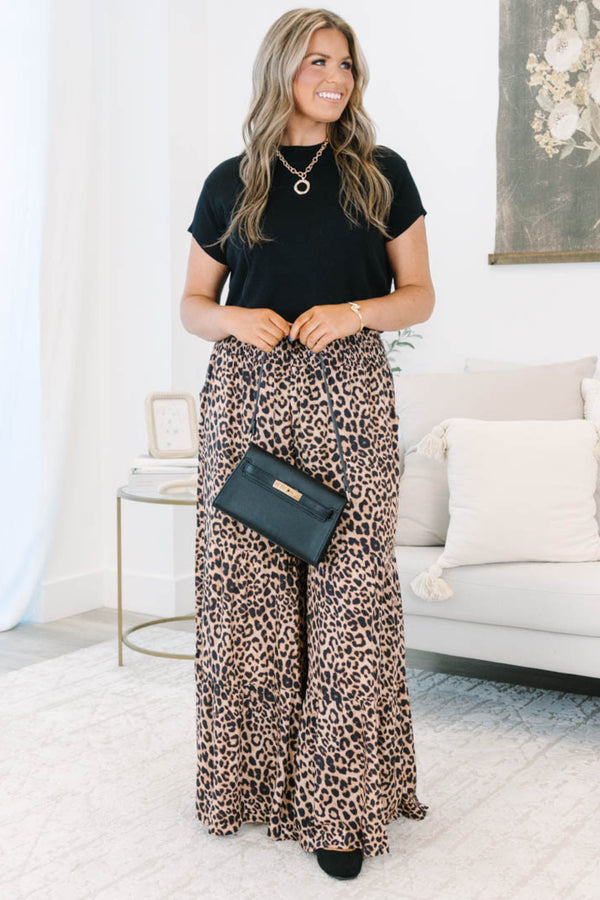 Plus Size wide-leg tiered pants in a dark leopard print with a smocked elastic waistband.
