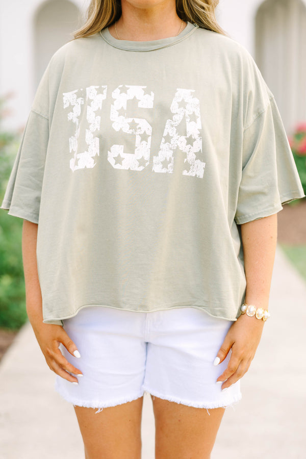 Plus Size army green vintage wash tee with white USA star graphic and white frayed denim shorts.