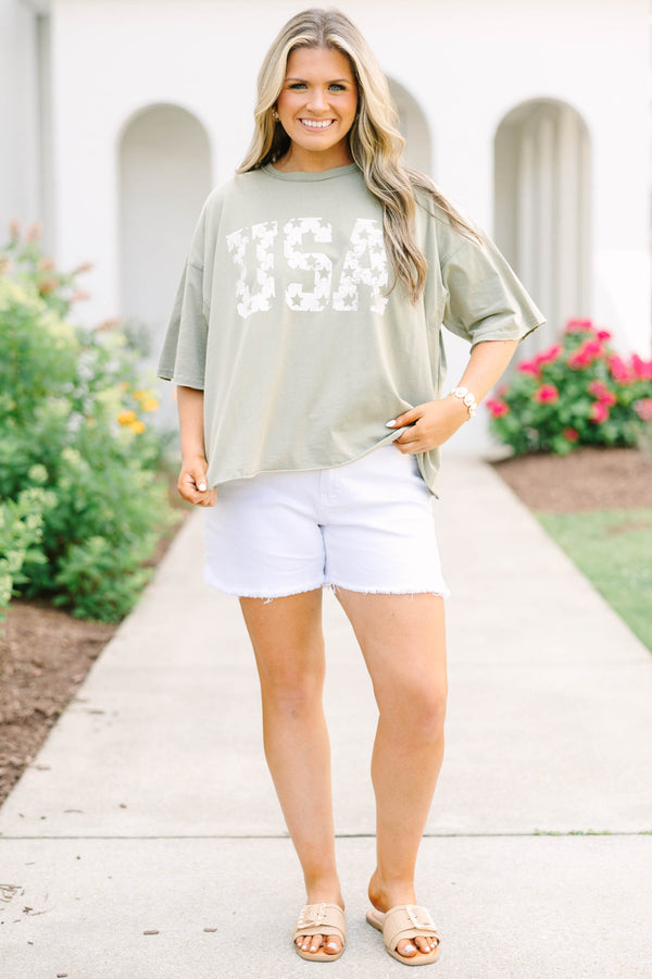 Plus Size army green vintage wash tee with white USA star graphic and white frayed denim shorts.