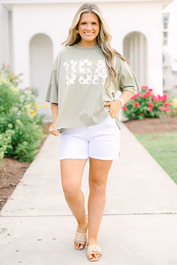 Plus Size army green vintage wash tee with white USA star graphic and white frayed denim shorts.
