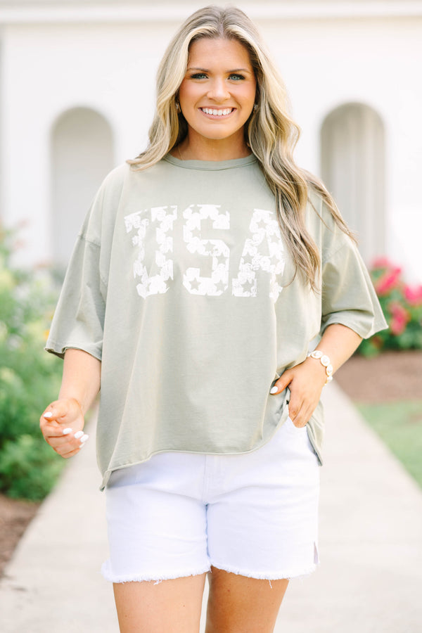 Plus Size army green vintage wash tee with white USA star graphic and white frayed denim shorts.