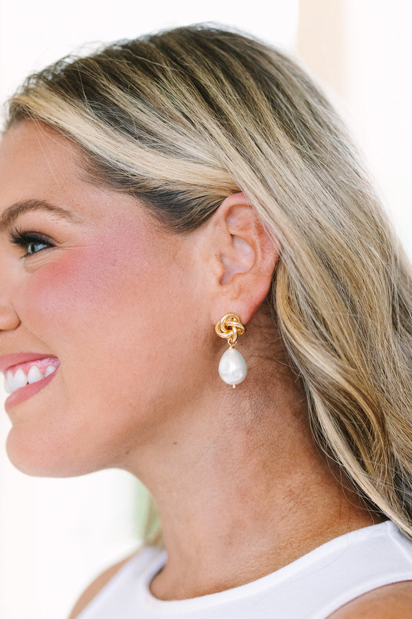 Plus Size gold knot stud earrings featuring dangling white baroque pearls.