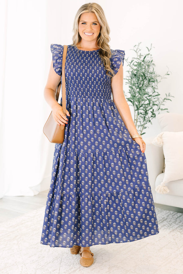 Plus Size navy tiered maxi dress with a smocked bodice, flutter sleeves, and a floral print.