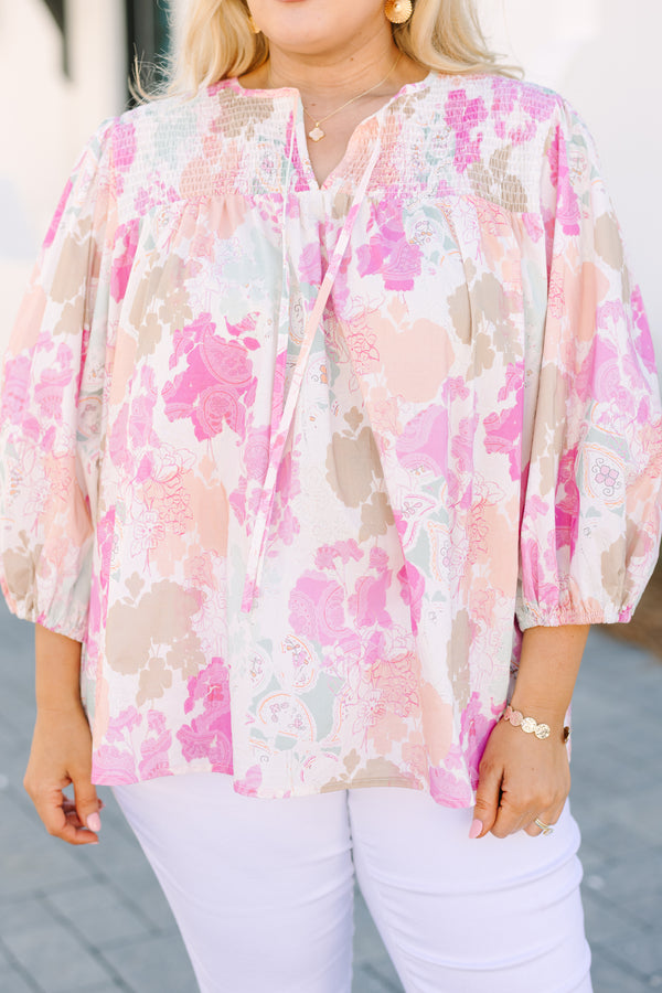 Chic Soul plus size clothing, pink top with half bubble sleeves a multi colored pink watercolor floral pattern as well as a smocked texture on the top of the chest and a slight v-neckline 
