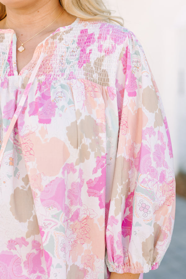 Chic Soul plus size clothing, pink top with half bubble sleeves a multi colored pink watercolor floral pattern as well as a smocked texture on the top of the chest and a slight v-neckline 
