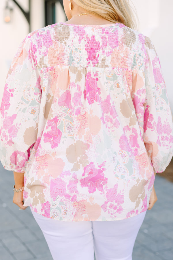 Chic Soul plus size clothing, pink top with half bubble sleeves a multi colored pink watercolor floral pattern as well as a smocked texture on the top of the chest and a slight v-neckline 
