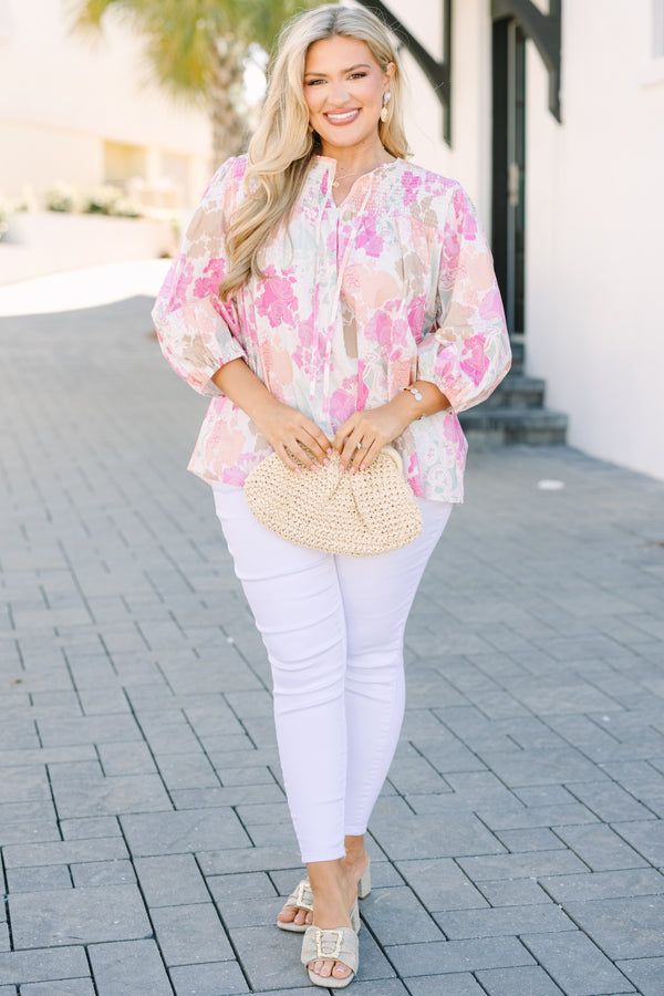 Chic Soul plus size clothing, pink top with half bubble sleeves a multi colored pink watercolor floral pattern as well as a smocked texture on the top of the chest and a slight v-neckline 
