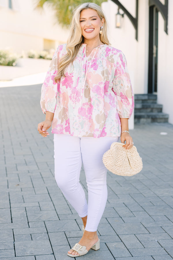 Chic Soul plus size clothing, pink top with half bubble sleeves a multi colored pink watercolor floral pattern as well as a smocked texture on the top of the chest and a slight v-neckline 
