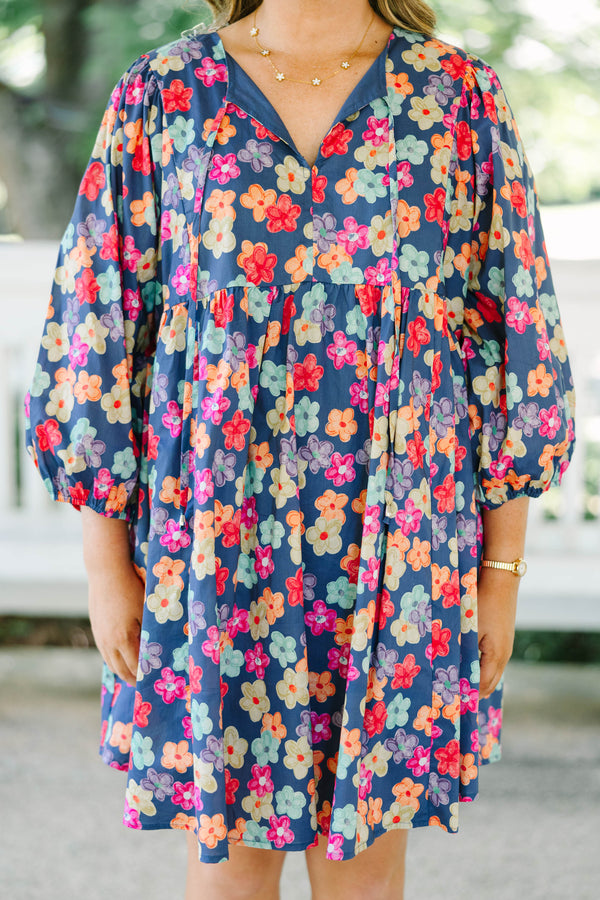 Plus size navy floral mini dress with a flowy fit, V-neckline, and three-quarter length sleeves.