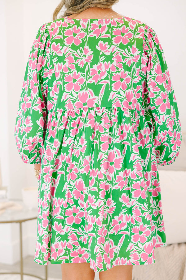 Plus size pink and green floral mini dress with flowy fit, long puff sleeves, and tassel ties.