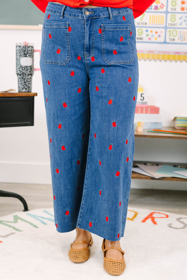 Plus Size cropped wide leg blue denim jeans with red bitten apple embroidery and frayed hem.