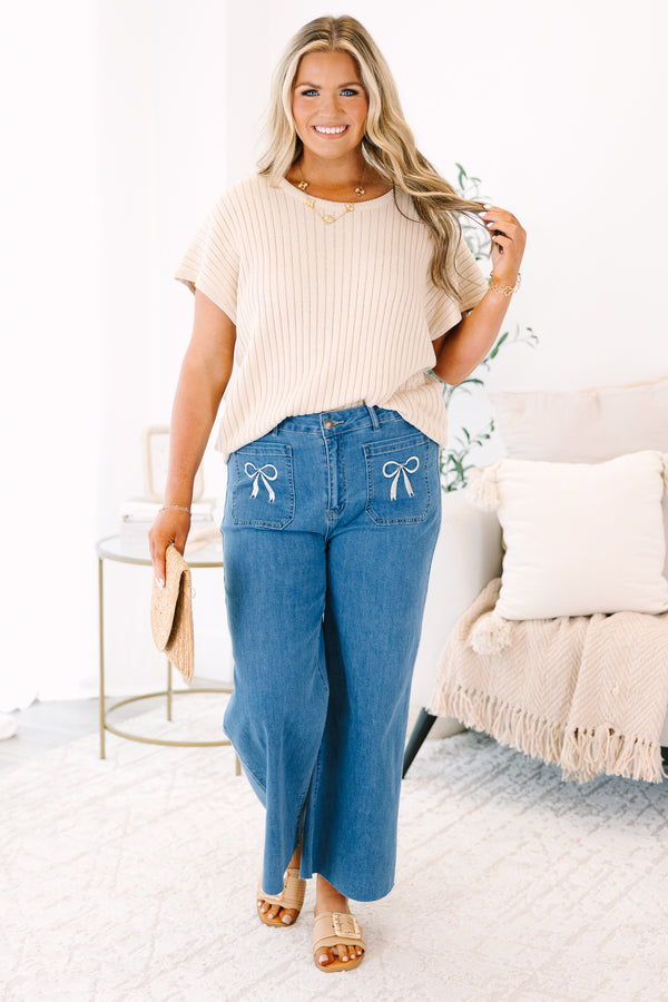 Plus Size wide-leg blue jeans with front patch pockets featuring white bow embroidery.
