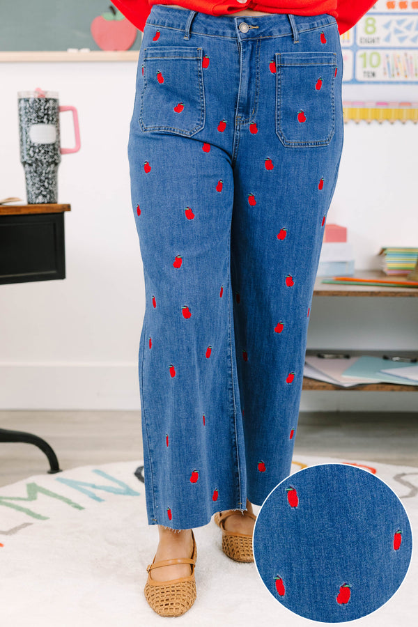 Plus Size cropped wide leg blue denim jeans with red bitten apple embroidery and frayed hem.