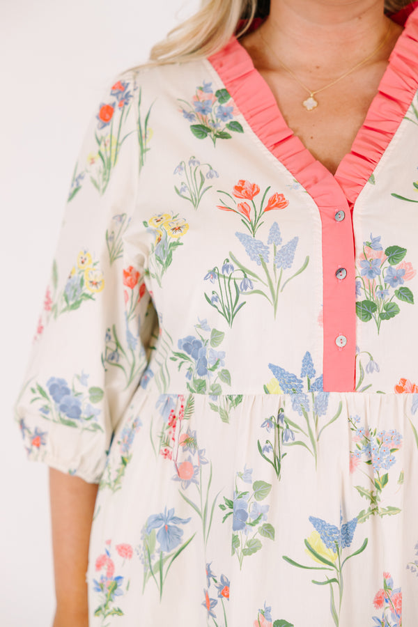 Chic Soul plus size clothing, cream maxi dress with half bubble sleeves along with a pink strip ruffle detail going along the v-neckline and a multi-colored floral pattern throughout