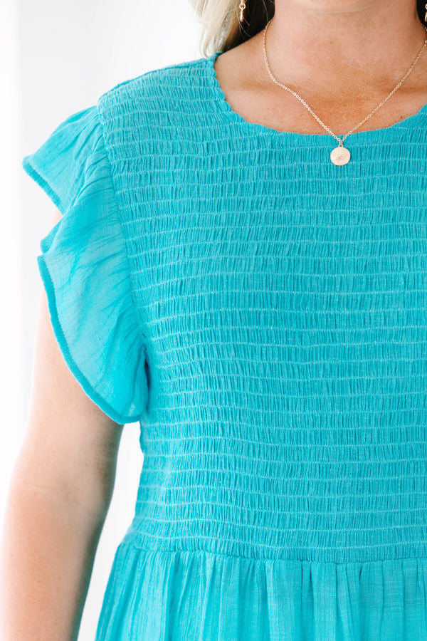 Plus Size turquoise smocked top with ruffle cap sleeves and a tiered babydoll silhouette.