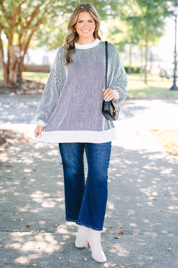 Plus Size oversized black and white vertical striped knit sweater with a crew neck and ribbed trim.