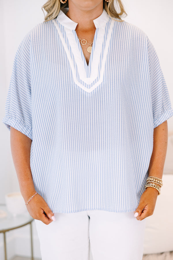 Plus Size blue and white vertical striped top with a white V-neckline and short sleeves.