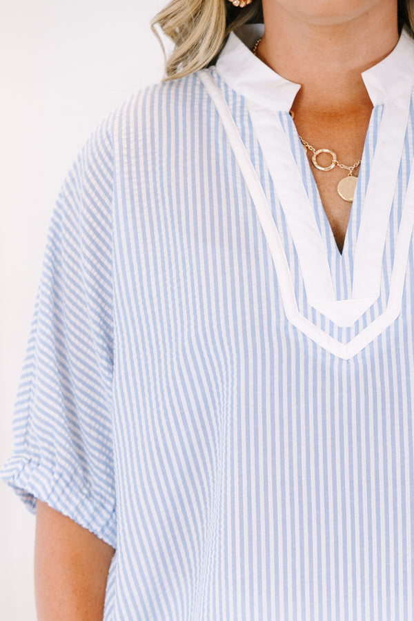 Plus Size blue and white vertical striped top with a white V-neckline and short sleeves.