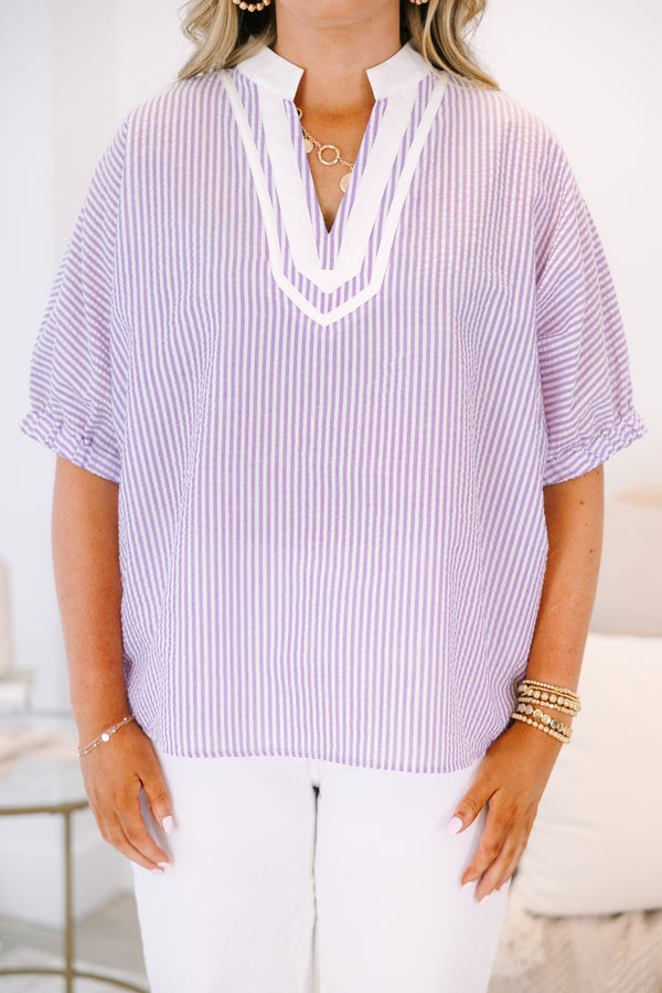 Plus Size lavender and white vertical striped top with a white V-neckline and short puff sleeves.