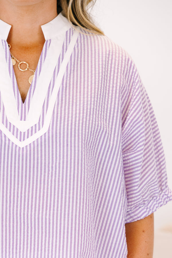 Plus Size lavender and white vertical striped top with a white V-neckline and short puff sleeves.